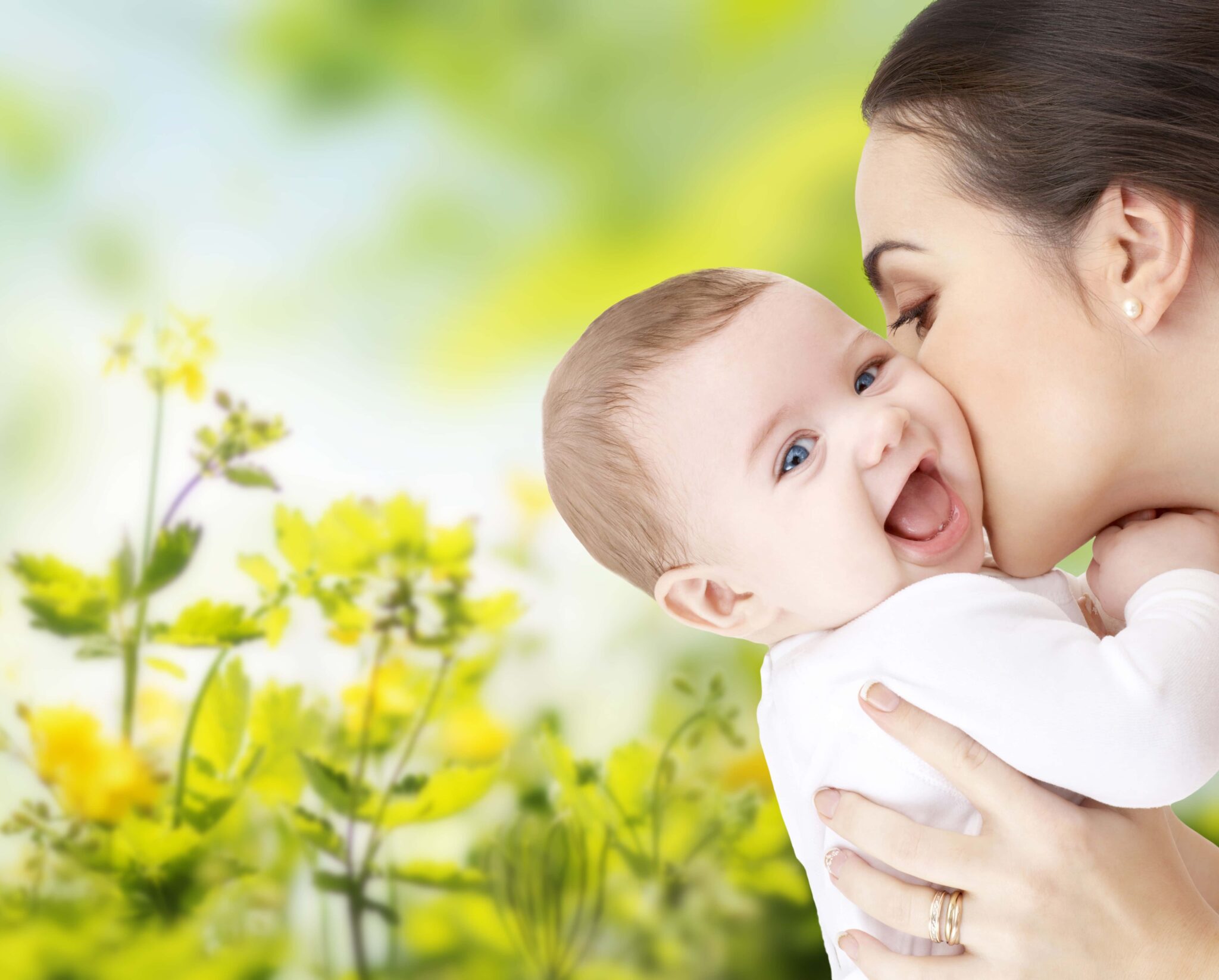 happy mother kissing adorable baby