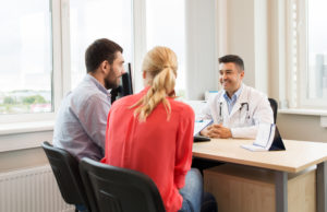 couple visiting doctor at family planning clinic couple visiting doctor at family planning clinic