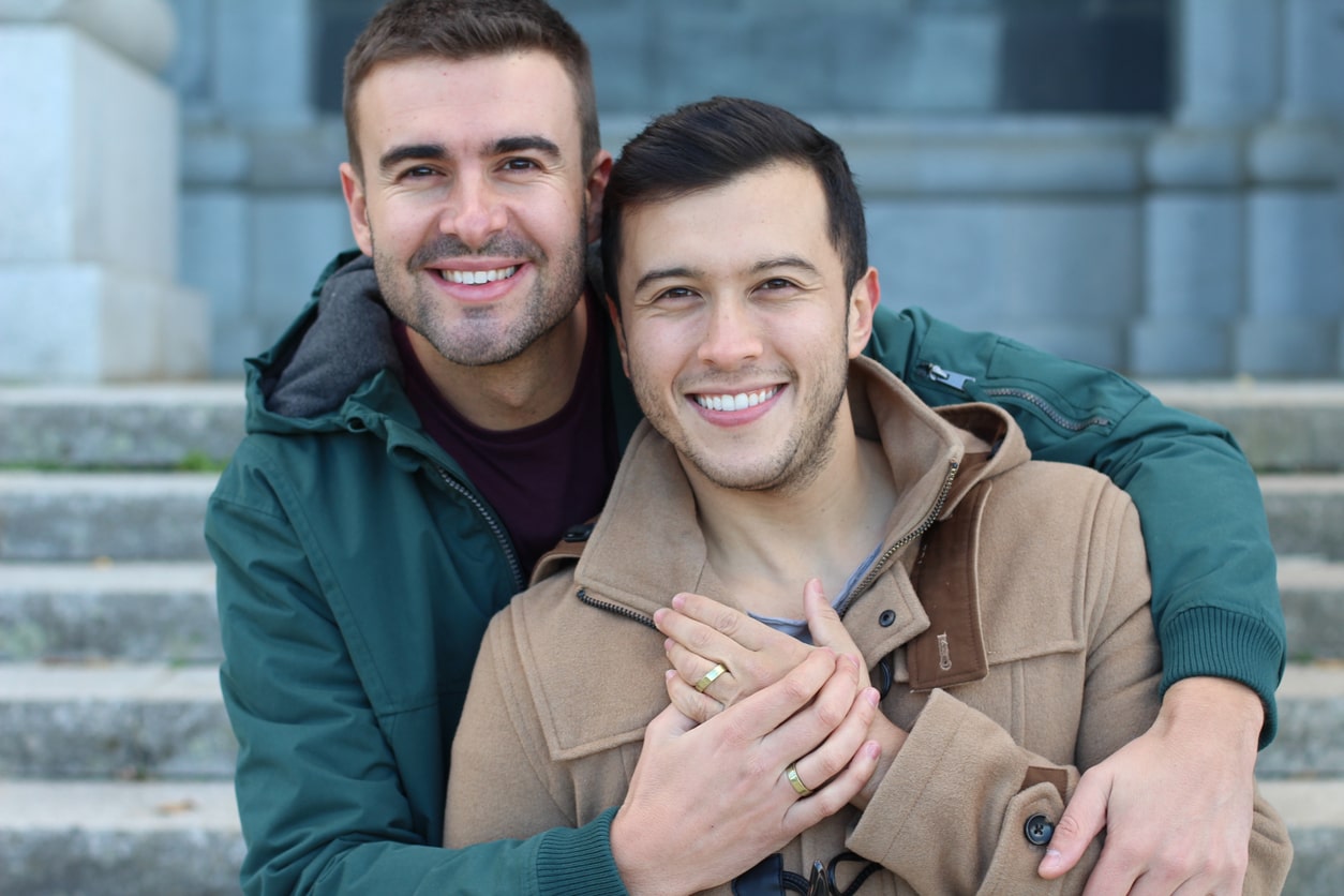 Happily married gay couple close up gestational surrogacy agency